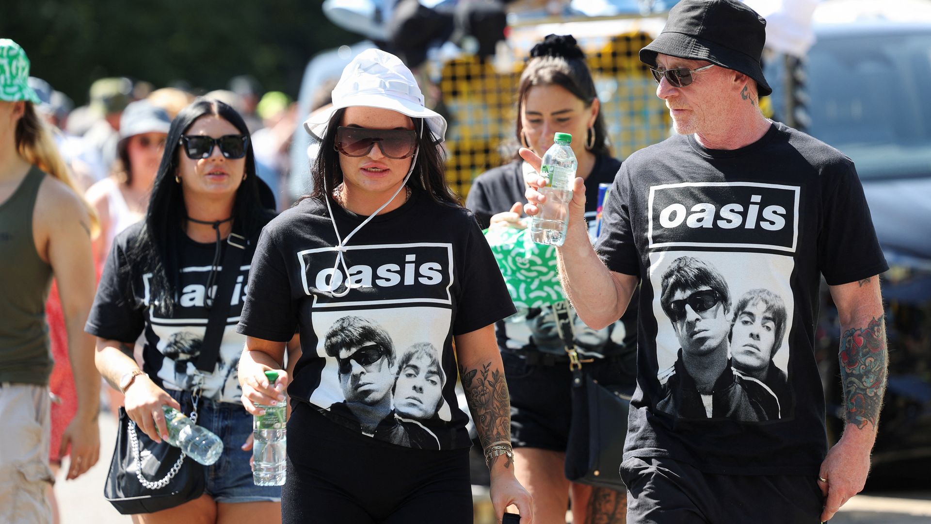 ‘A significant cultural event’: Oasis supporters wait in line throughout the day for a homecoming concert in Manchester.